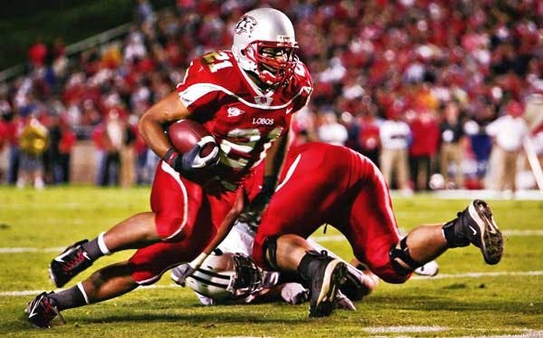 UNM tailback Rodney Ferguson carries a pass in the third quarter against BYU on Saturday at University Stadium.  