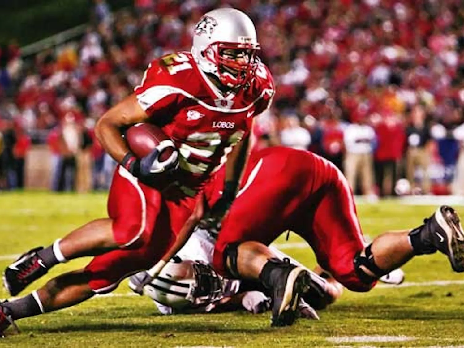 UNM tailback Rodney Ferguson carries a pass in the third quarter against BYU on Saturday at University Stadium.