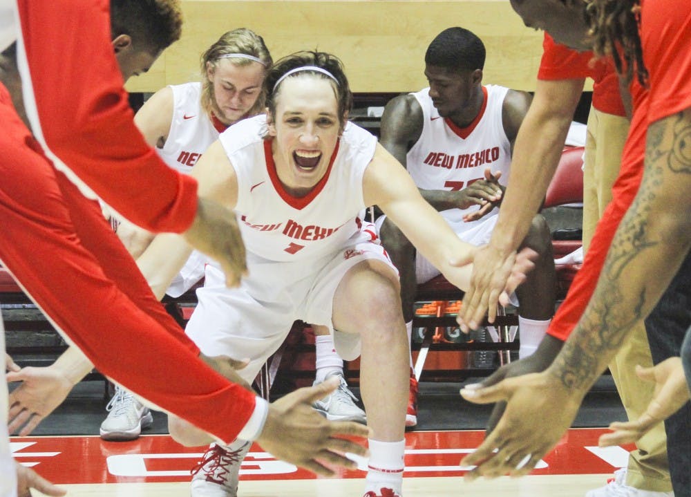 New Mexico sophomore guard Cullen Neal gives fives to his teammates as he takes the floor for Saturday’s exhibition game against Western New Mexico. Neal scored 22 points in an 89-45 win, the Lobos’ first exhibition game of the 2013-14 season.