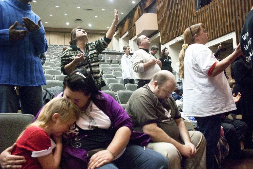 A small crowd collapses in ecstatic rapture during Ugandan missionary John Wakabi's song-speech in Woodward Hall. About 300 attended the weekend event.