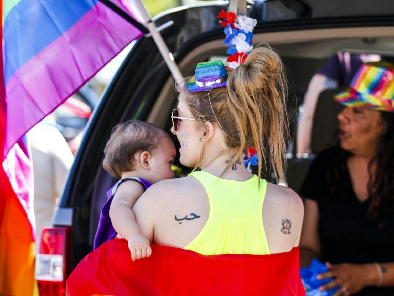 A woman holds her baby during the Albuquerque Pride Parade on June 10, 2017. The parade’s route changed from Central this year to Lomas and Washington toward Expo New Mexico due to the ART construction.
