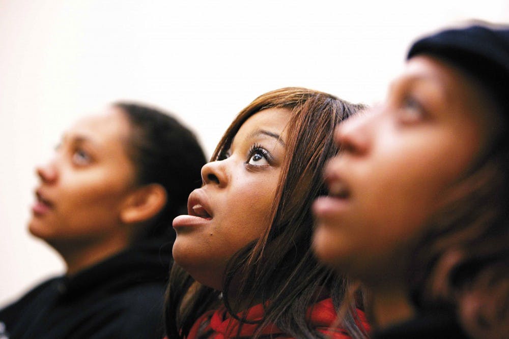Tiffany Hale, center, sings with fellow sopranos Jaime Griffin, left, and Antoinette Murphy during a UNM Gospel Choir practice in the SUB on Tuesday. 