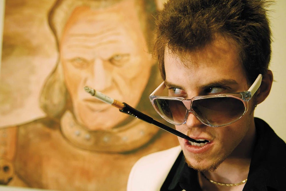 Local artist David Horowitz stands in front of his work, "Vigo the Carpathian," on Sunday. The painting is a depiction of the villain from the film "Ghostbusters 2." Horowitz is selling the piece for $11,200. 