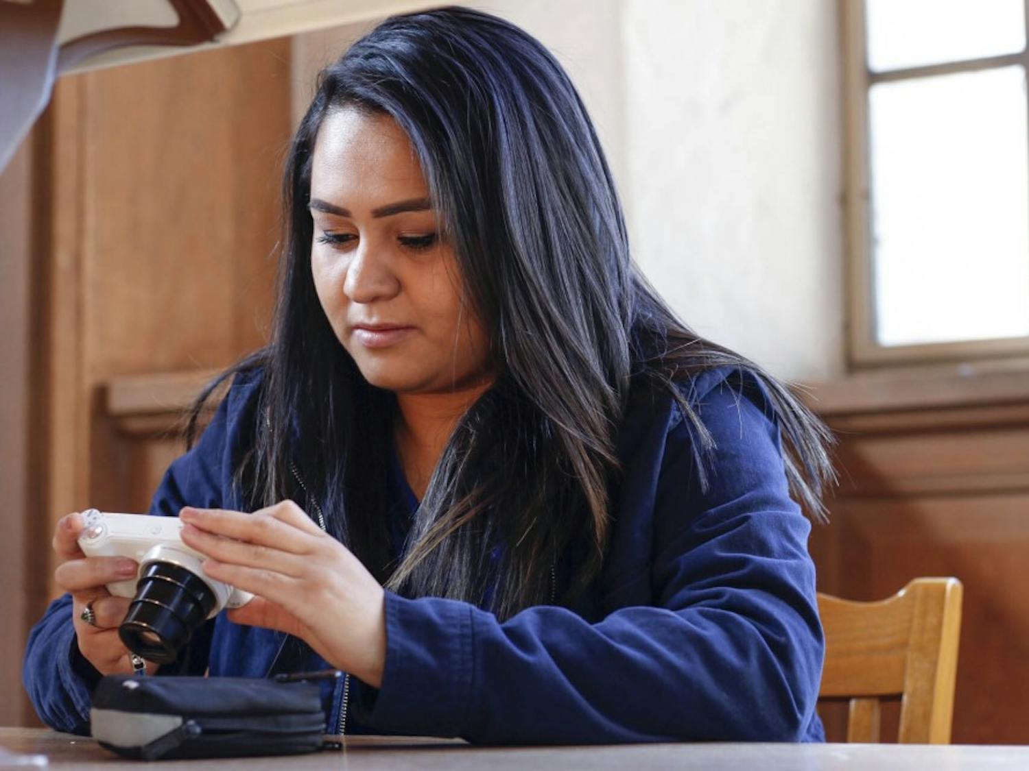 Vanessa Espinoza works on her camera at Zimmerman Library on Dec. 9, 2017. Vanessa is a mass communication and journalism major from El Paso, Texas and will be graduating this Fall.