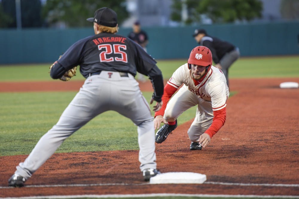 Junior Luis Gonzalez slides back into first base during the Lobos’ game against Texas Tech on Tuesday, April 25, 2017 at Santa Ana Star Field.