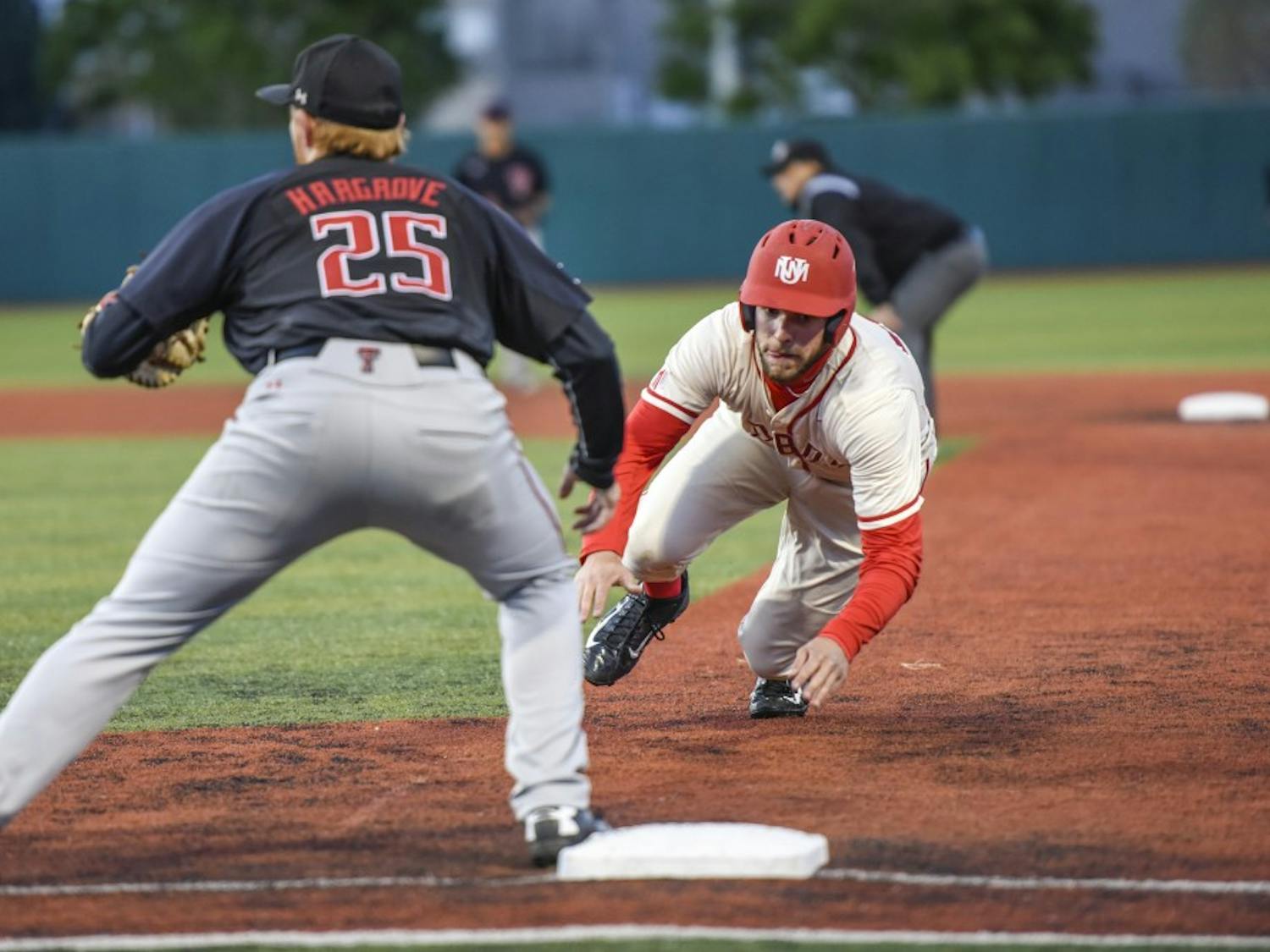 Junior Luis Gonzalez slides back into first base during the Lobos’ game against Texas Tech on Tuesday, April 25, 2017 at Santa Ana Star Field.