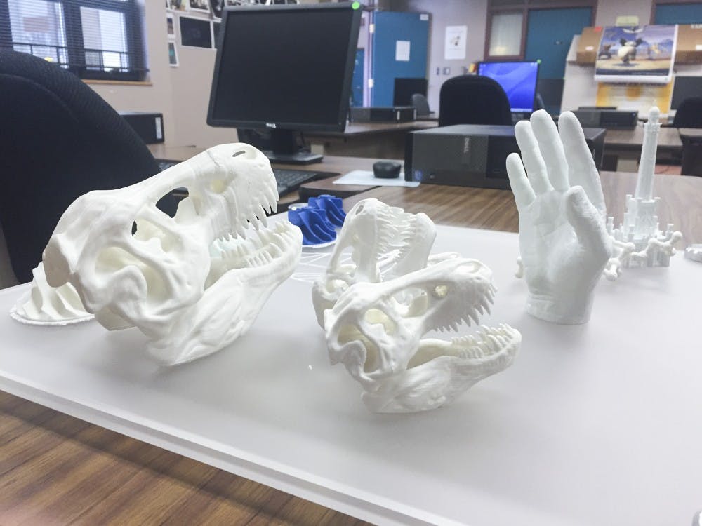 A 3D printed dinosaur skull and human hand lay on a table at the office of Del Alex Sanchez at UNM Valencia campus on Tuesday. UNM Valencia will offer a certificate in 3D printing in the fall.
