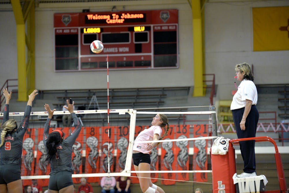 Outside hitter/middle blocker Cassie House leaps for a kill against UNLV on Saturday at Johnson Center. The Lobos defeated the Rebels 3-1.