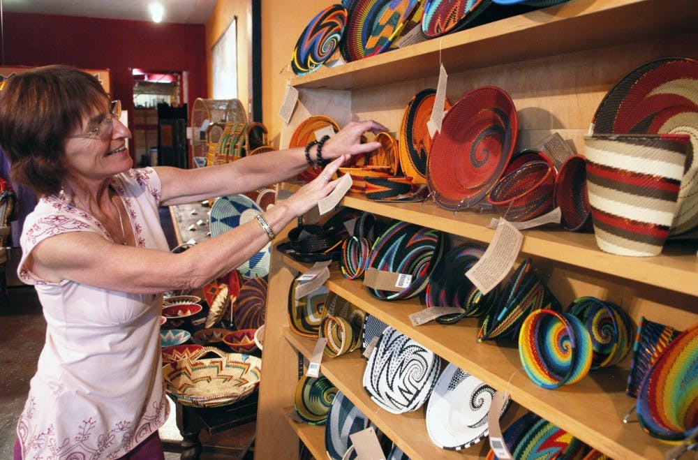 	Sharon Cantrell, outreach director for Peacecraft, rearranges baskets made from telephone wire. The Nob Hill store is a nonprofit business that raises money for underdeveloped countries.