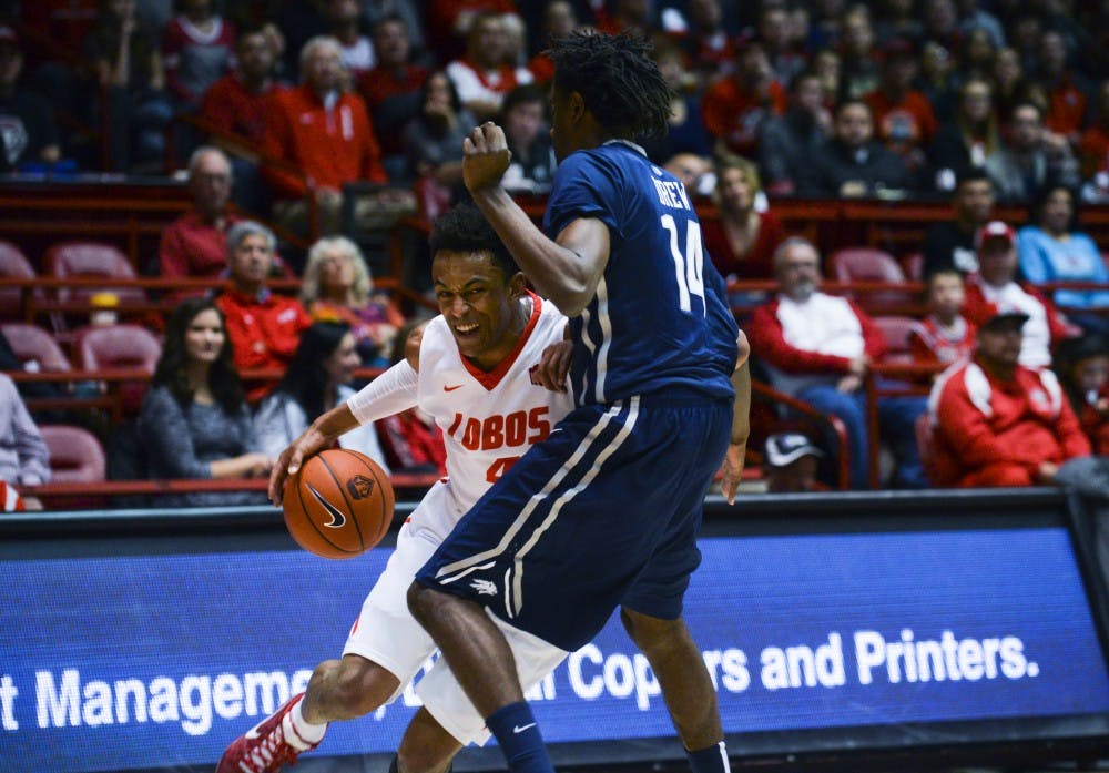 Redshirt sophomore guard Elijah Brown drives to the net against a University of Nevada player at WisePies Arena Dec. 30. The Lobos take on Utah State this Saturday at 4 p.m..