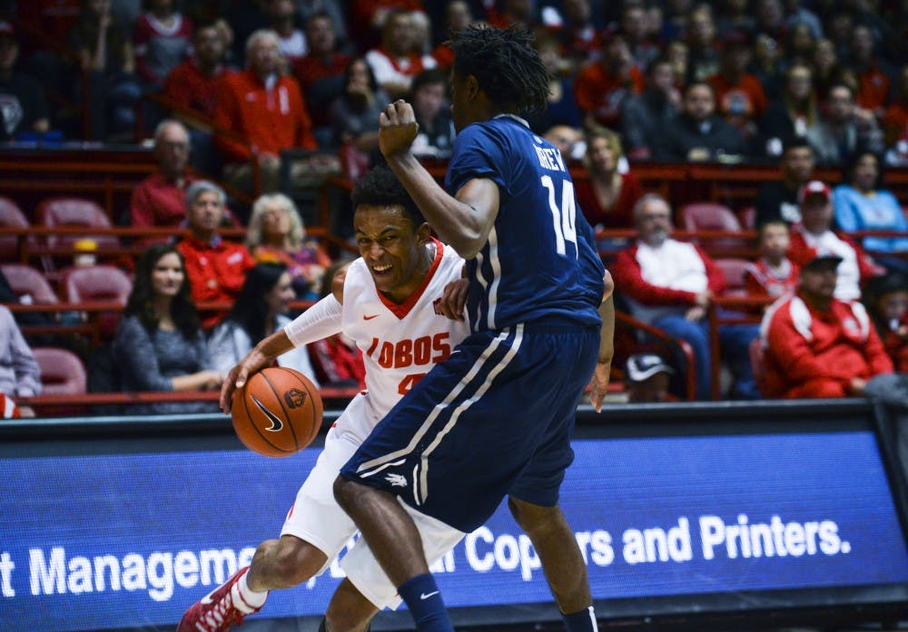 Redshirt sophomore guard Elijah Brown drives to the net against a University of Nevada player at WisePies Arena Dec. 30. The Lobos take on Utah State this Saturday at 4 p.m..