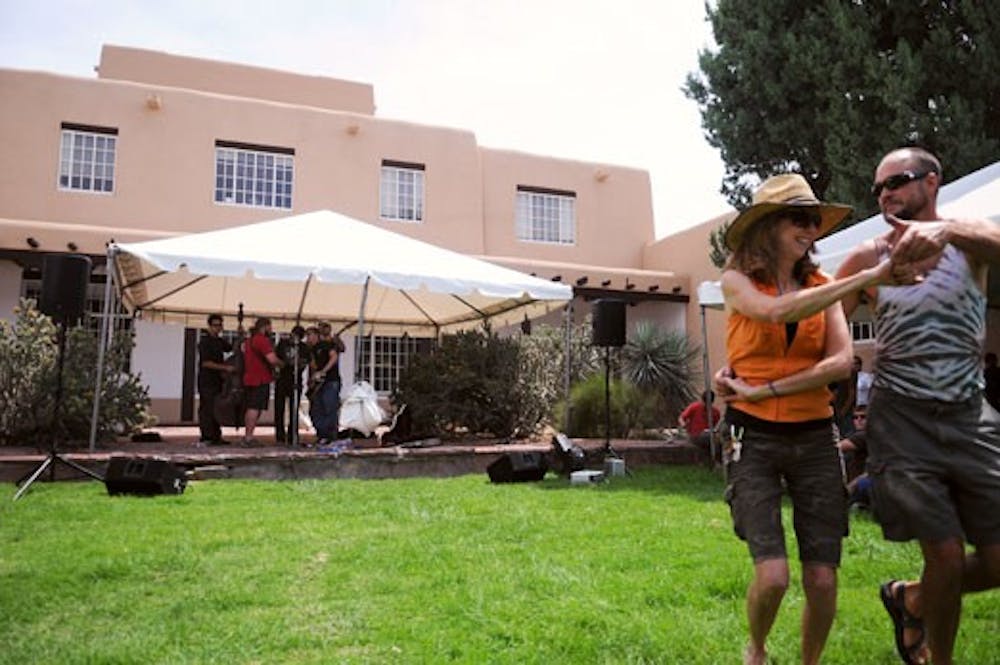 Dino Freeman and Ellie Slick dance to the music of Squash Blossom Boys at Women's and Cultural Day on Wednesday.  