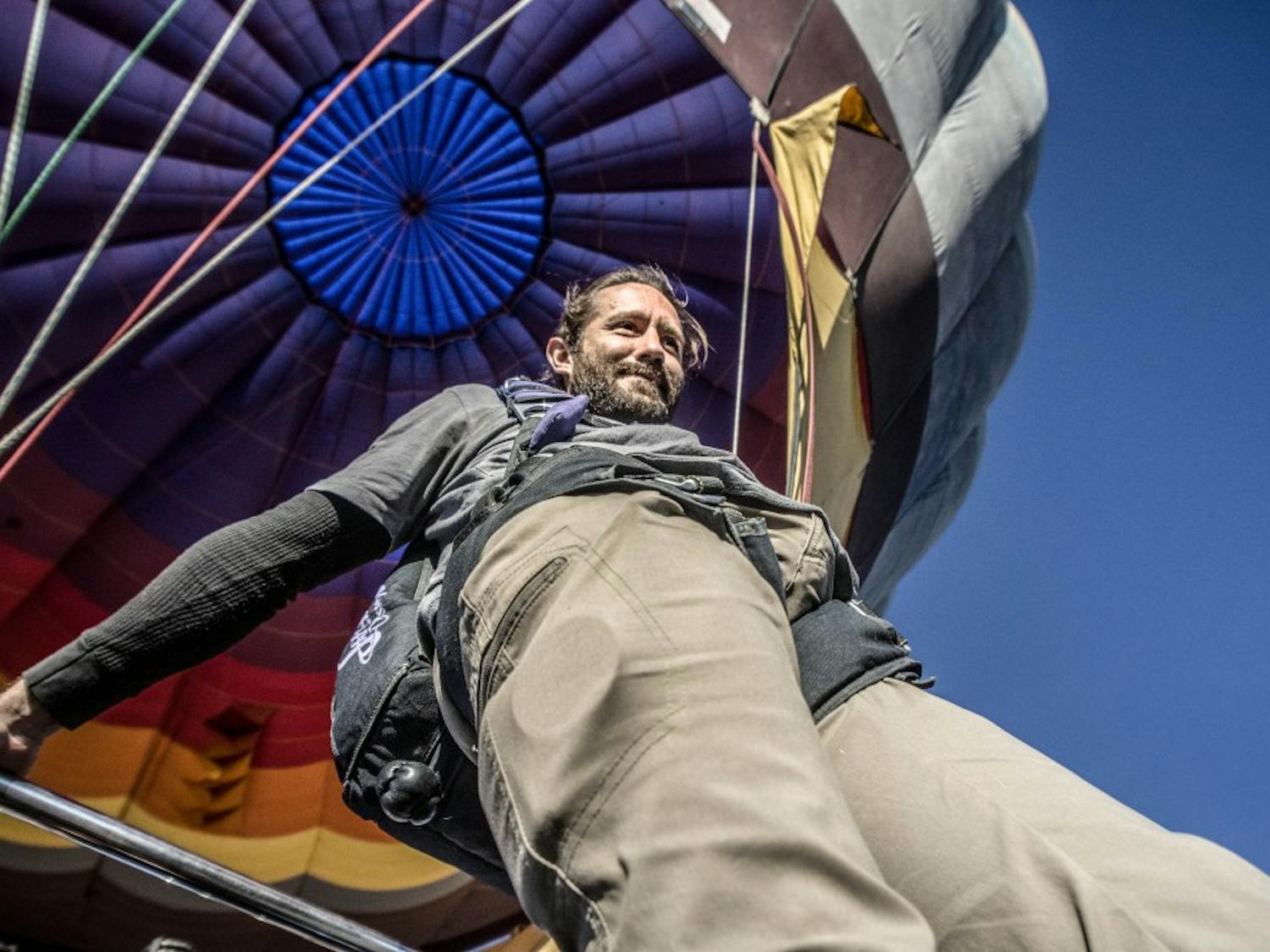 Jake Cordova prepares to jump off of the gondola of a hot air balloon, before plummeting 11,000 feet back down to Rio Rancho, NM, on Oct. 17, 2017. 
