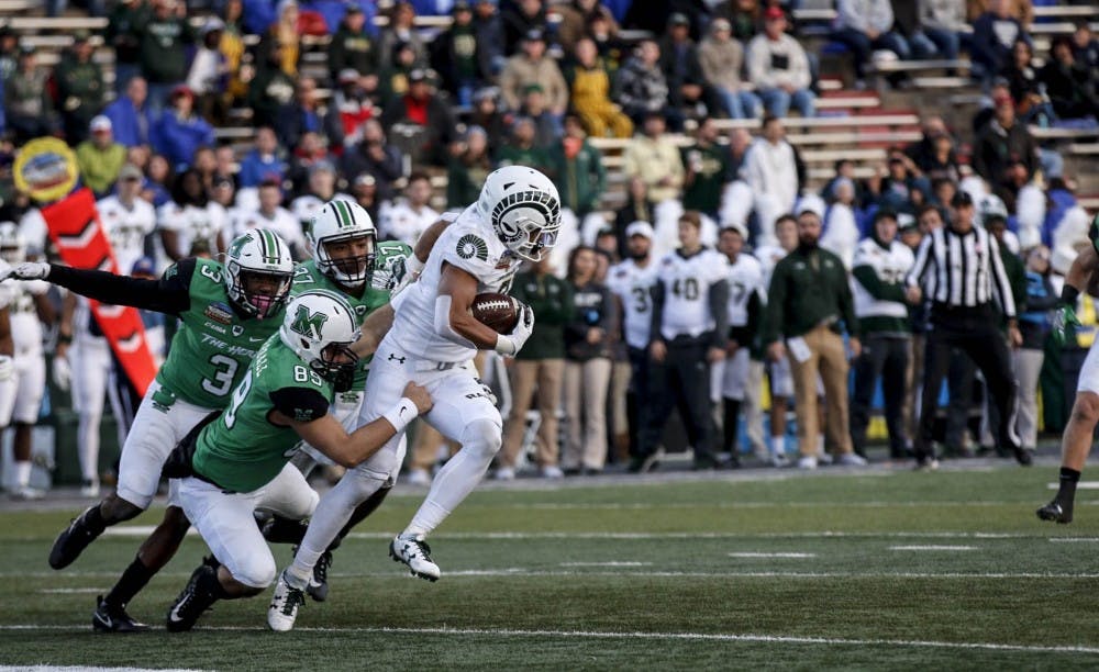 Olabisi Johnson #81 junior wide receiver gets tackled by three defenders from Marshall at the Dreamstyle Stadium on Dec. 16, 2017.