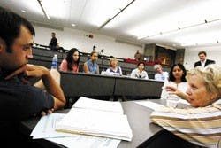 UNM law student Matt Durkovich, left, listens to faculty member Christine Rack talk about Guantanamo Bay after a panel spoke about the detainment camp Thursday at the UNM School of Law.  