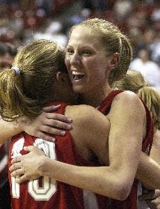 Julie Briody, left, hugs teammate Katie Montgomery as the buzzer sounds ending the final round of the Mountain West Conference Women's Basketball Championship Saturday in Las Vegas. The Lobos won 63-49.