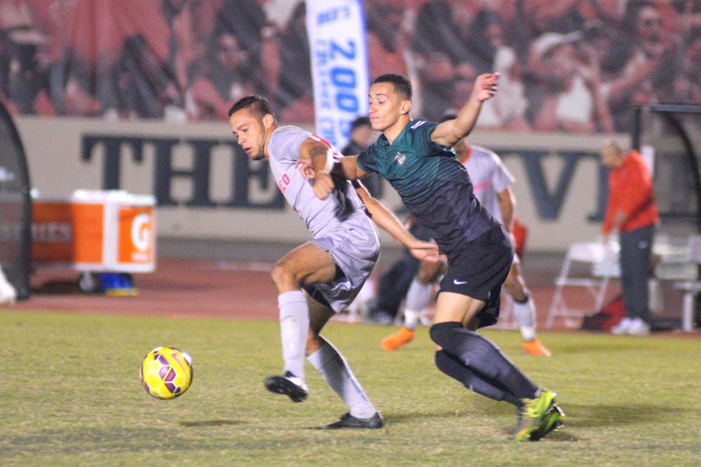 Junior forward Niko Hansen fights for the ball against a Charlotte player at the UNM Soccer Complex Tuesday, Oct. 27. The Lobos tied with Florida International this past weekend and play Florida National Friday, Nov. 6 at 7 p.m..