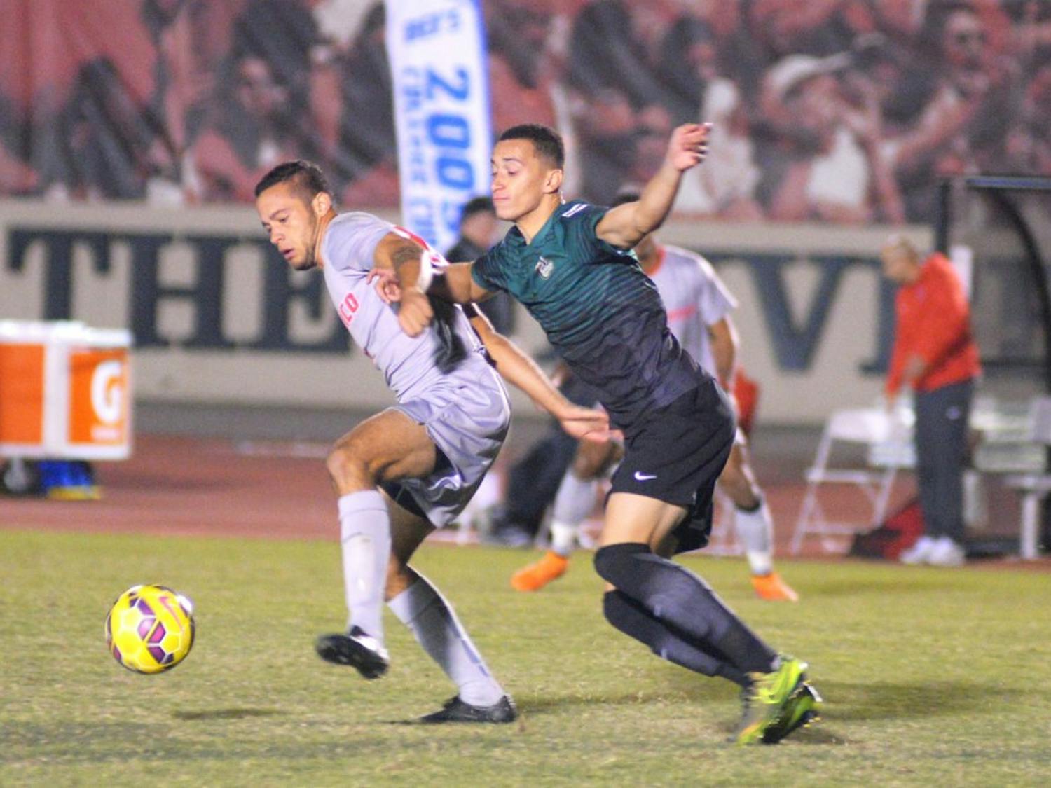 Junior forward Niko Hansen fights for the ball against a Charlotte player at the UNM Soccer Complex Tuesday, Oct. 27. The Lobos tied with Florida International this past weekend and play Florida National Friday, Nov. 6 at 7 p.m..