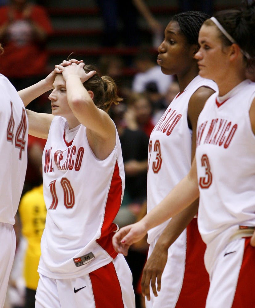UNM's Amy Beggin, left, Dionne Marsh, center, and Eileen Weissmann walk on the court after the Lobos lost to BYU on Saturday at The Pit.  