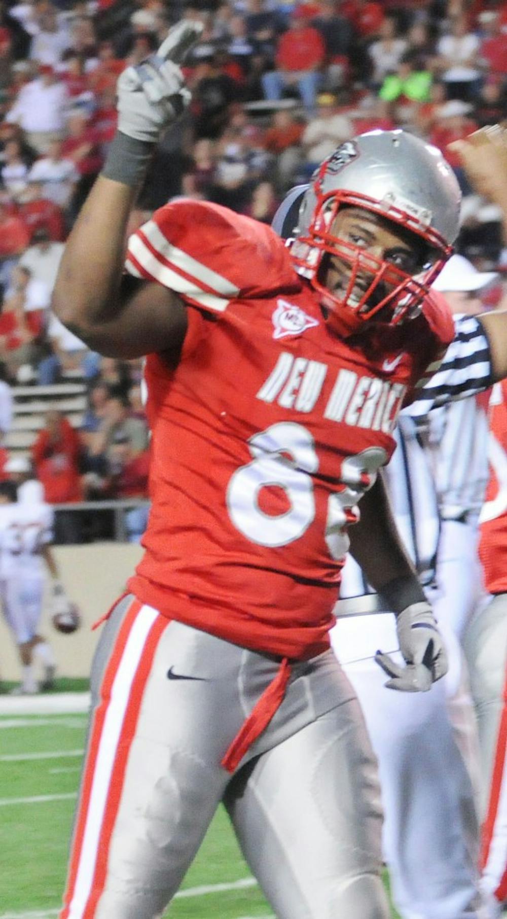 	Johnathan Rainey raises his arms in celebration in this file photo. The Lobos’ defensive end has 6 ½ sacks so far this season. The Lobos will head to Wyoming on Saturday in search of their first win.