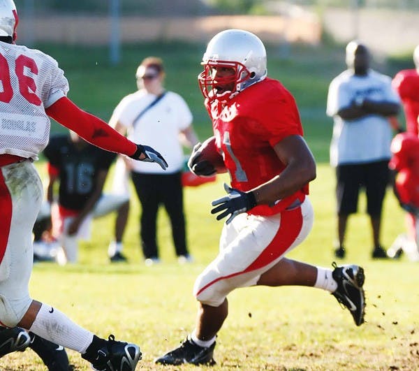 UNM tailback Rodney Ferguson runs the ball during practice Wednesday at the Lobo football practice field. 