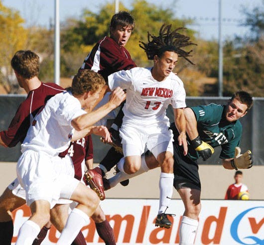 UNM midfielder David Gualdarama, center, collides with Denver goalie Matt Bredehoft, far right, after a pass to Gualdarama was blocked by Denver defense during Sunday's game at the UNM Soccer Complex. The Lobos won their last home game 3-0.