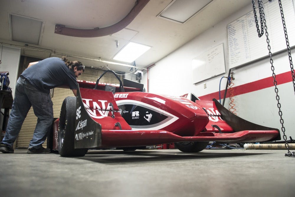Estevan Pina, a senior mechanical engineering student, reaches into UNM’s Formula SAE motorsports program 2014 car on Nov. 14. The program has been ranked No. 5 in the country and No. 18 in the world, according to a poll issued by the Formula Student Combustion World Rankings.