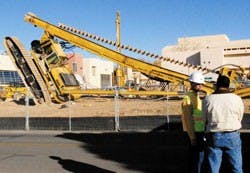 Project Lead Michael Reid, left, talks to a man who witnessed a two-and-a-half story drilling rig fall over at the construction site of the Centennial Science and Engineering Center on Friday. Authorities are investigating whether the accident was caused 