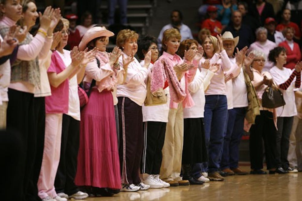 Cancer survivors applaud during halftime at Wednesday's game at The Pit.