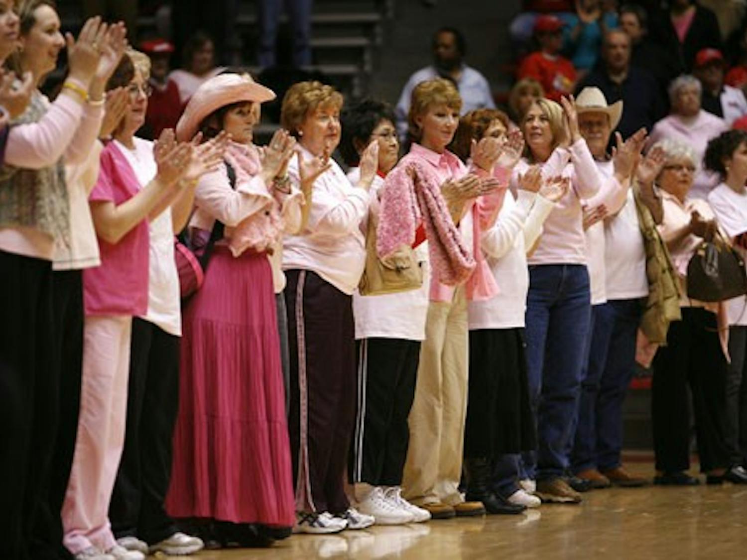 Cancer survivors applaud during halftime at Wednesday's game at The Pit.