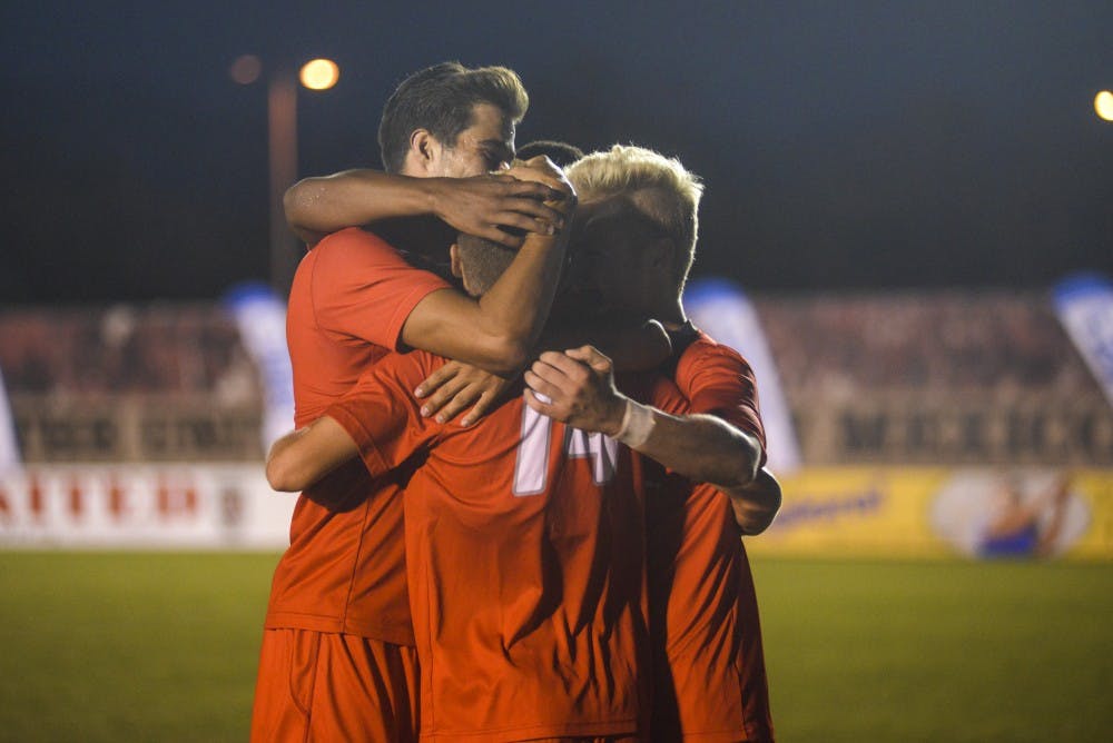 Senior midfielder Chris Wehan, 14, celebrates with his teammates after scoring the Lobos' second goal during the second half on Sunday, Sept. 4, 2016 at the UNM Soccer Complex. The Lobos defeated Cal Poly 2-0.