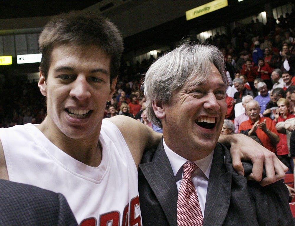 	Roman Martinez wraps his arm around assistant coach Craig Neal after a Dec. 2 win over California. Martinez again was key in UNM’s victory over NMSU on Saturday. He had 21 points and eight rebounds.