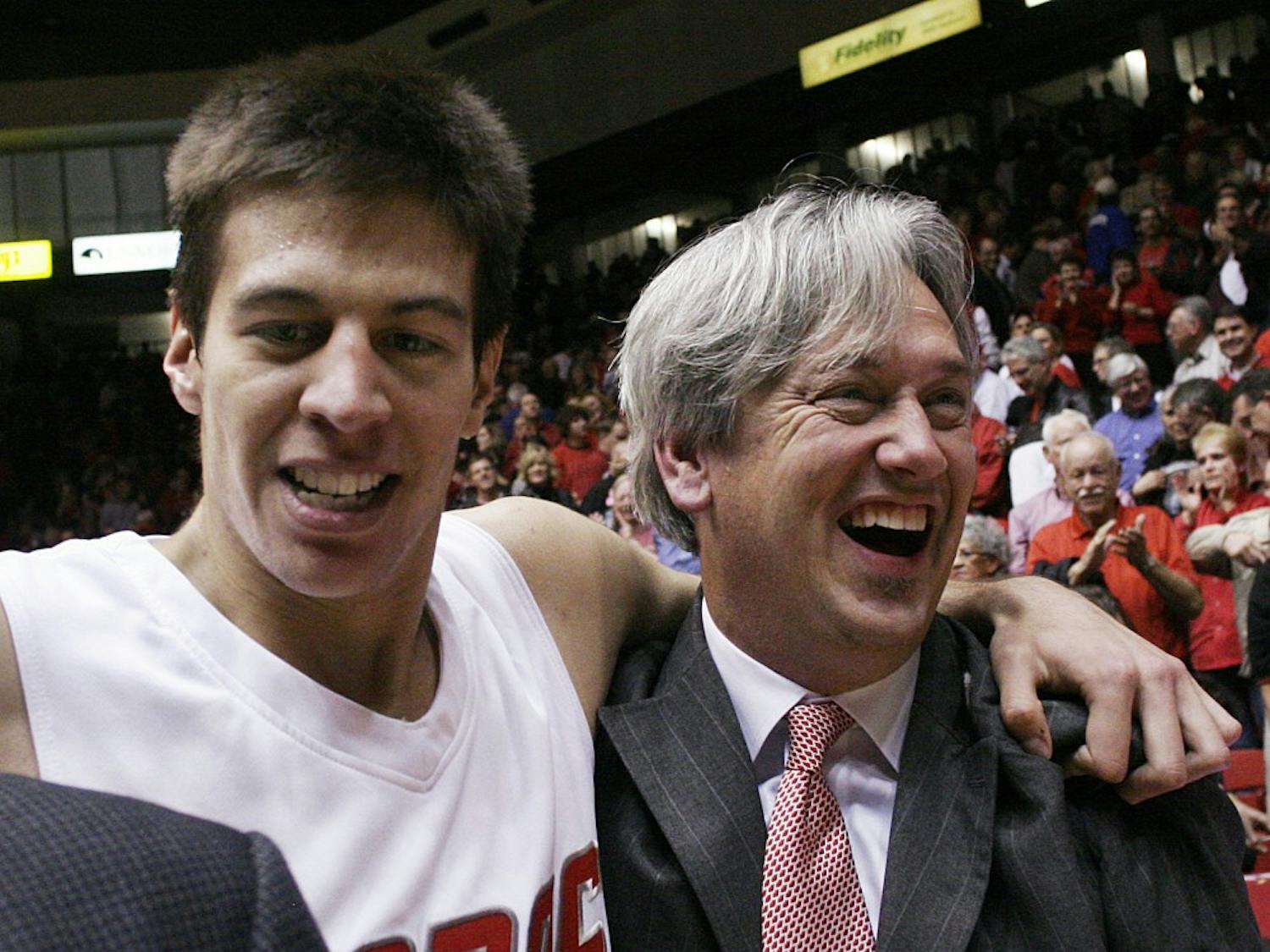 Roman Martinez wraps his arm around assistant coach Craig Neal after a Dec. 2 win over California. Martinez again was key in UNM’s victory over NMSU on Saturday. He had 21 points and eight rebounds.