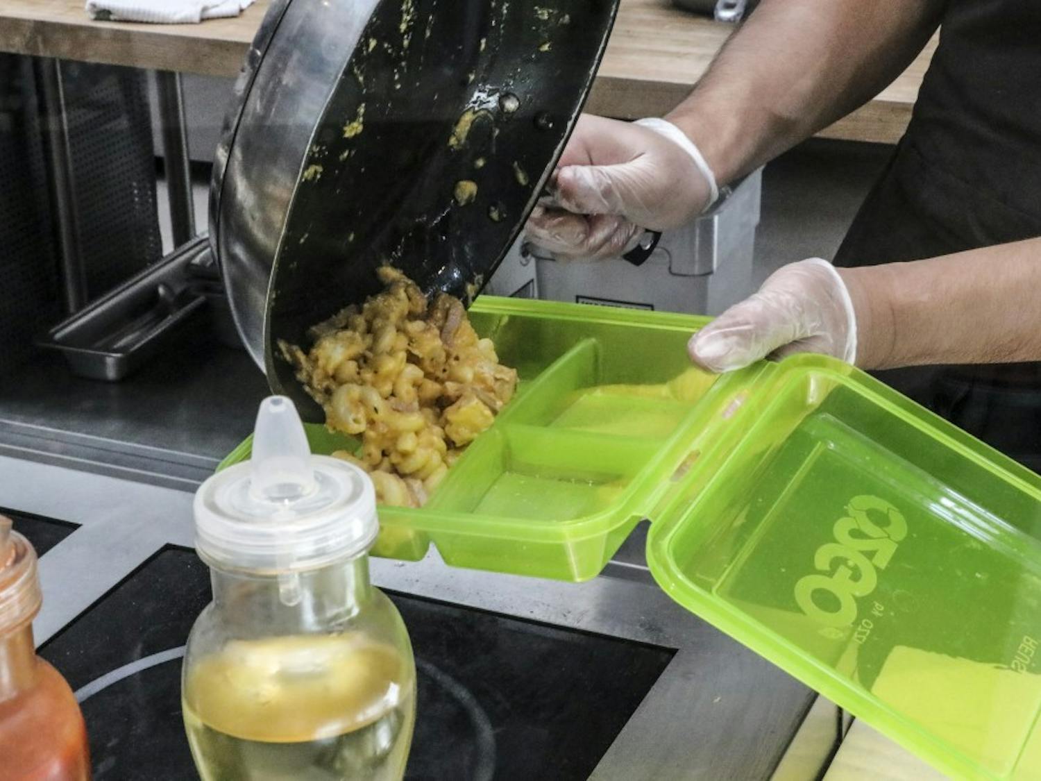 A La Posada cook fills one of the new LaPo To-Go boxes with Mac & Cheese on Aug. 26, 2018.