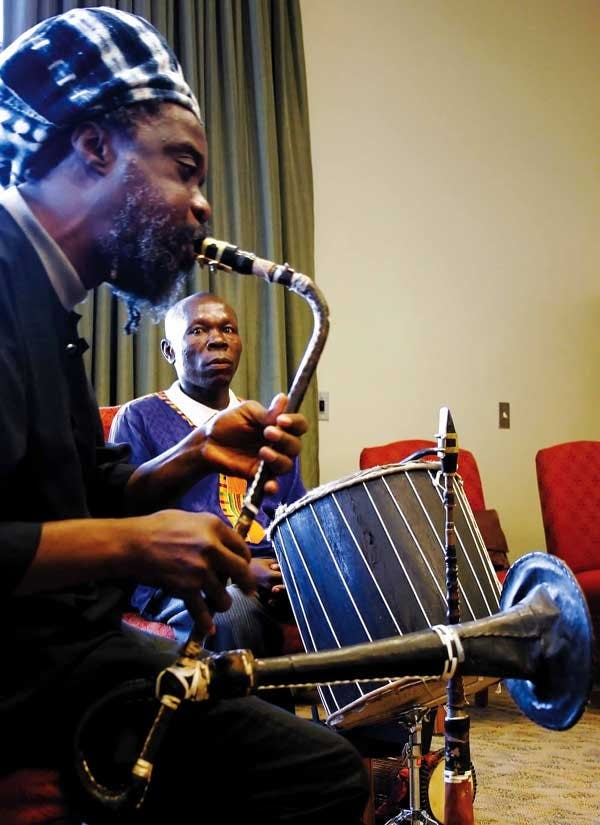 Nii Otoo Annan watches Nii Noi Nortey play an afrifone Wednesday in the SUB. They are visiting UNM from Accra, Ghana, this week.