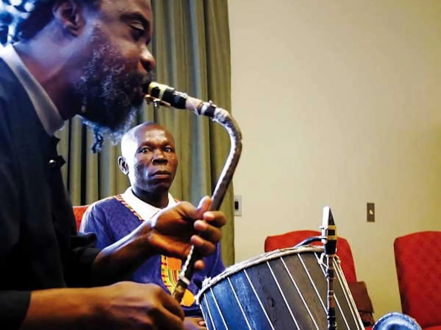 Nii Otoo Annan watches Nii Noi Nortey play an afrifone Wednesday in the SUB. They are visiting UNM from Accra, Ghana, this week.