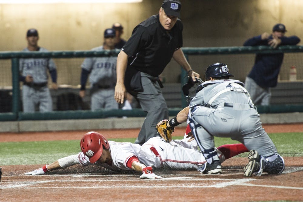 Senior infielder Dalton Bowers slides into home base as a Dallas Baptist catcher tries to tag him out Friday night at Santa Ana Star Field. The Lobos lost to Dallas Baptist 5-2 in their first of three games.&nbsp;