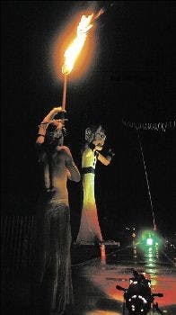 Ojo del Fuego fire dancer Cohdi Harrelly prepares to perform at Zozobra in Santa Fe on Thursday.