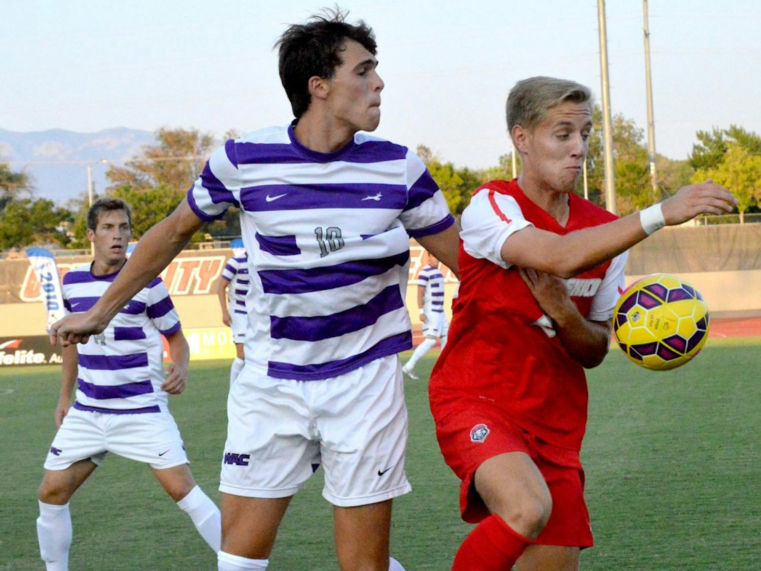New Mexico forward Sam Gleadle beats a Grand Canyon player to the ball during a preseason exhibition Wednesday night at the UNM Soccer Complex.