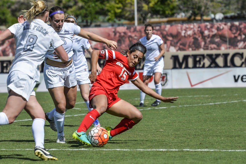 Senior defender Olivia Ferrier slides into a group of Air Force players on Sunday, Sept. 25, 2016 at the UNM Soccer Complex. The Lobos lost to UNLV 2-1.&nbsp;
