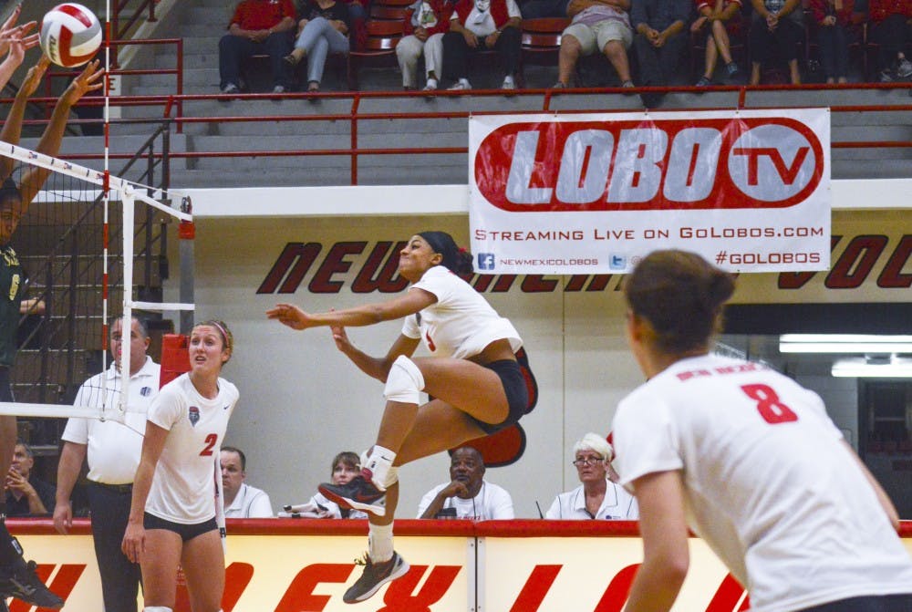 Lobo redshirt senior right-side hitter Chantale Riddle, center, jumps while keeping the ball in play during the game against Colorado State on Saturday at Johnson Gym. Riddle has been declared Mountain West Player of the Week twice this season.
