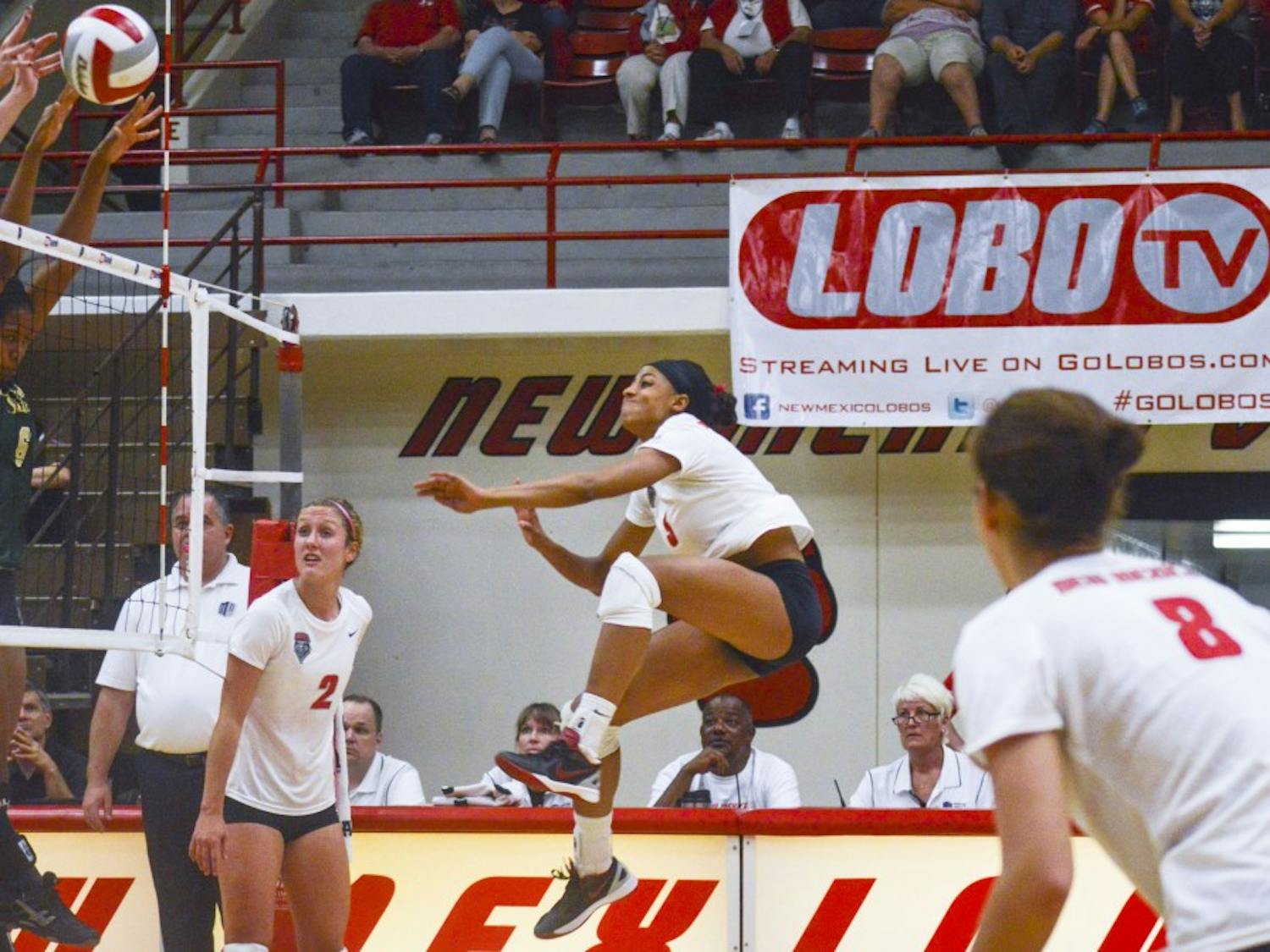 Lobo redshirt senior right-side hitter Chantale Riddle, center, jumps while keeping the ball in play during the game against Colorado State on Saturday at Johnson Gym. Riddle has been declared Mountain West Player of the Week twice this season.