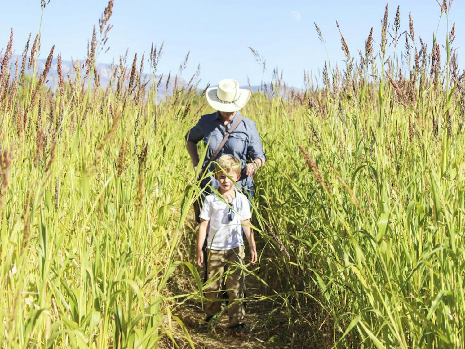 Lisa Young and Jack Lemelin, 5, participate in a scavenger hunt at the grand opening of the Maize Maze on Friday afternoon. The Maize Maze incorporates learning as a key component for the event. This year’s maze focuses on farming and fractals.