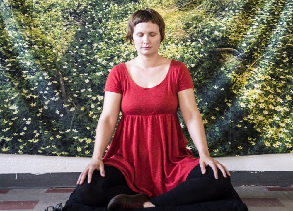 Amanda Dean meditates at United Methodist Church for the Compassion Project on Wednesday. Dean aimed to provide the community with a free ongoing yoga and meditation project unaffiliated with any religious tradition.