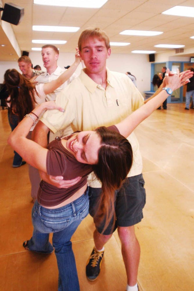 Rachelle Bustamante practices a waltz routine with her partner Karl Kalm during their ballroom dancing class in Johnson Gym on Wednesday. 
