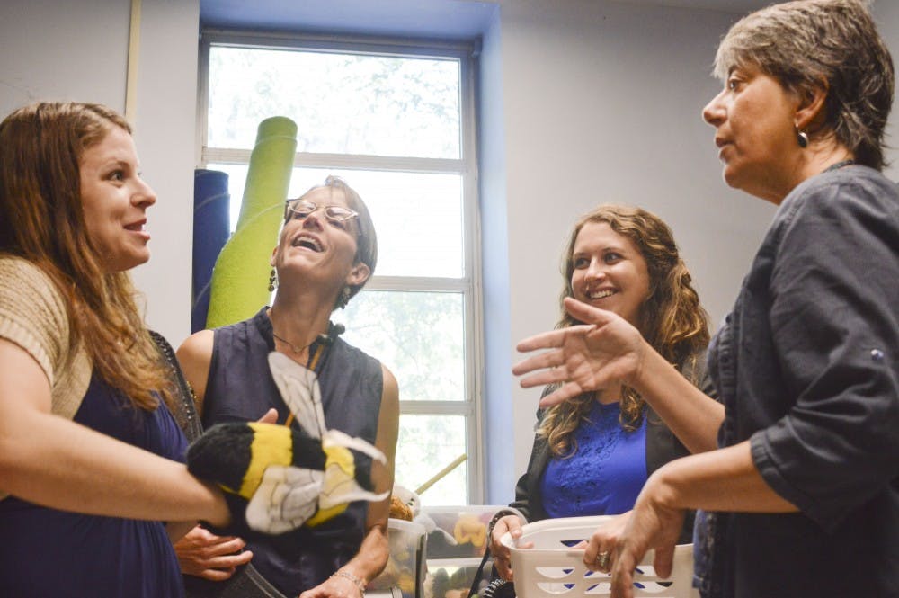 	(left to right) Robin Giebelhausen, professor of music education; Julia Church Hoffman, director of UNM Music Prep School; Katherine Oldberg, program coordinator of Music Prep School and Regina Carlow, associate dean for College of Fine Arts, share a laugh while cleaning out a room at Popejoy Hall on Aug. 14. This room will soon be filled with the sounds of young students learning the craft of musical thinking.
