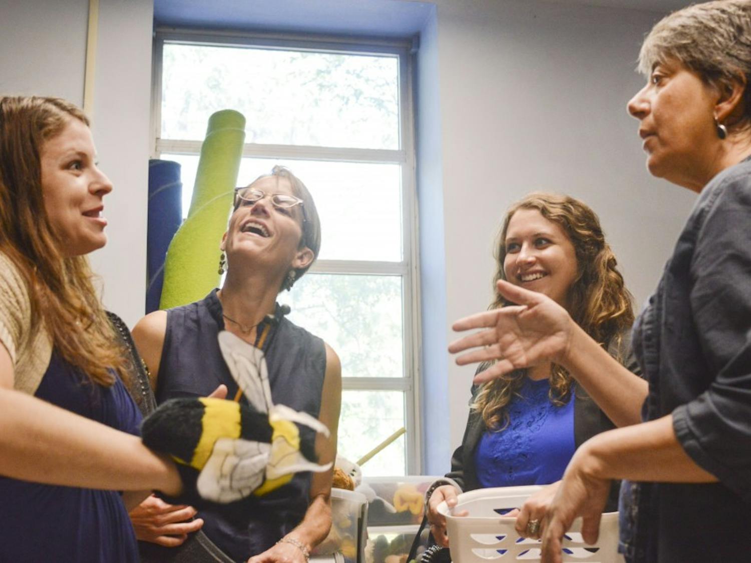 (left to right) Robin Giebelhausen, professor of music education; Julia Church Hoffman, director of UNM Music Prep School; Katherine Oldberg, program coordinator of Music Prep School and Regina Carlow, associate dean for College of Fine Arts, share a laugh while cleaning out a room at Popejoy Hall on Aug. 14. This room will soon be filled with the sounds of young students learning the craft of musical thinking.