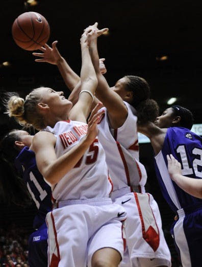 Lobos Amanda Adamson, left, and Georonika Jackson scramble for a loose ball during Sunday's 75-63 win over TCU. UNM improved to 15-3 and 4-1 in the Mountain West Conference.