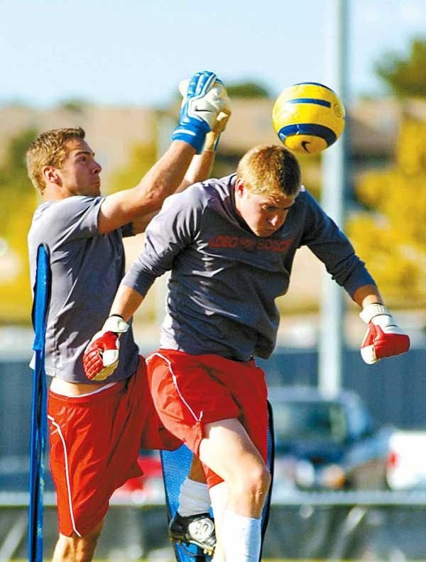 Lobo goalkeeper Mike Graczyk, left, and Justin Fite run goalie drills during a practice at Robertson Field.