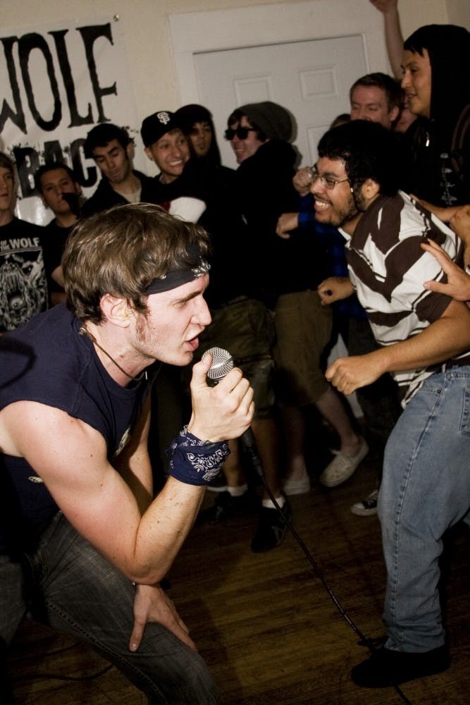 	Kendal Fortson, lead singer for Stabbed In Back screams into the microphone, energizing moshing fans. The band is a melodic punk band from Albuquerque. 